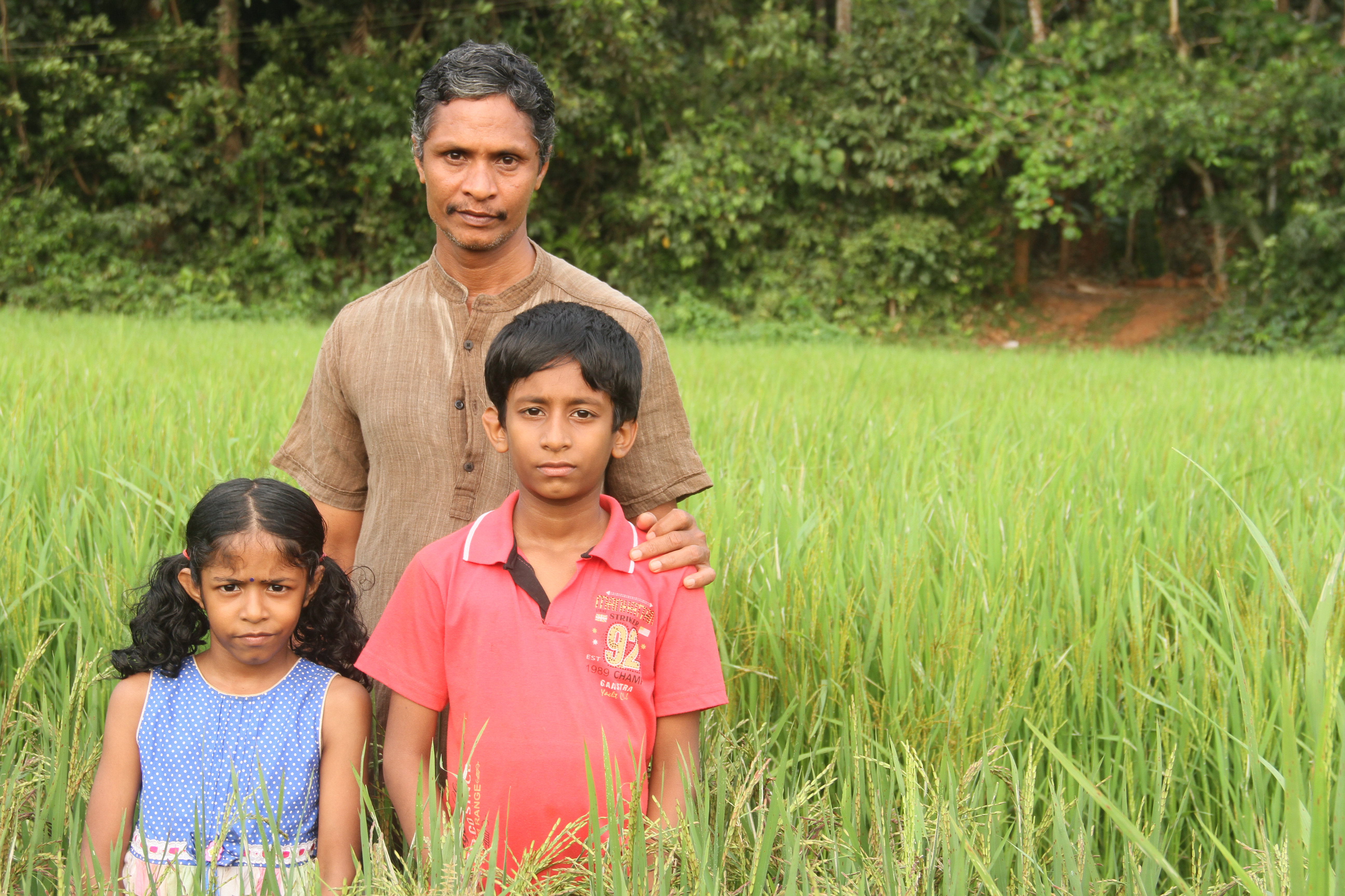 Jayakrishnan, conservator of 118 rare rice varieties, with his children Jayakrishnan, conservator of 118 rare rice varieties, with his children